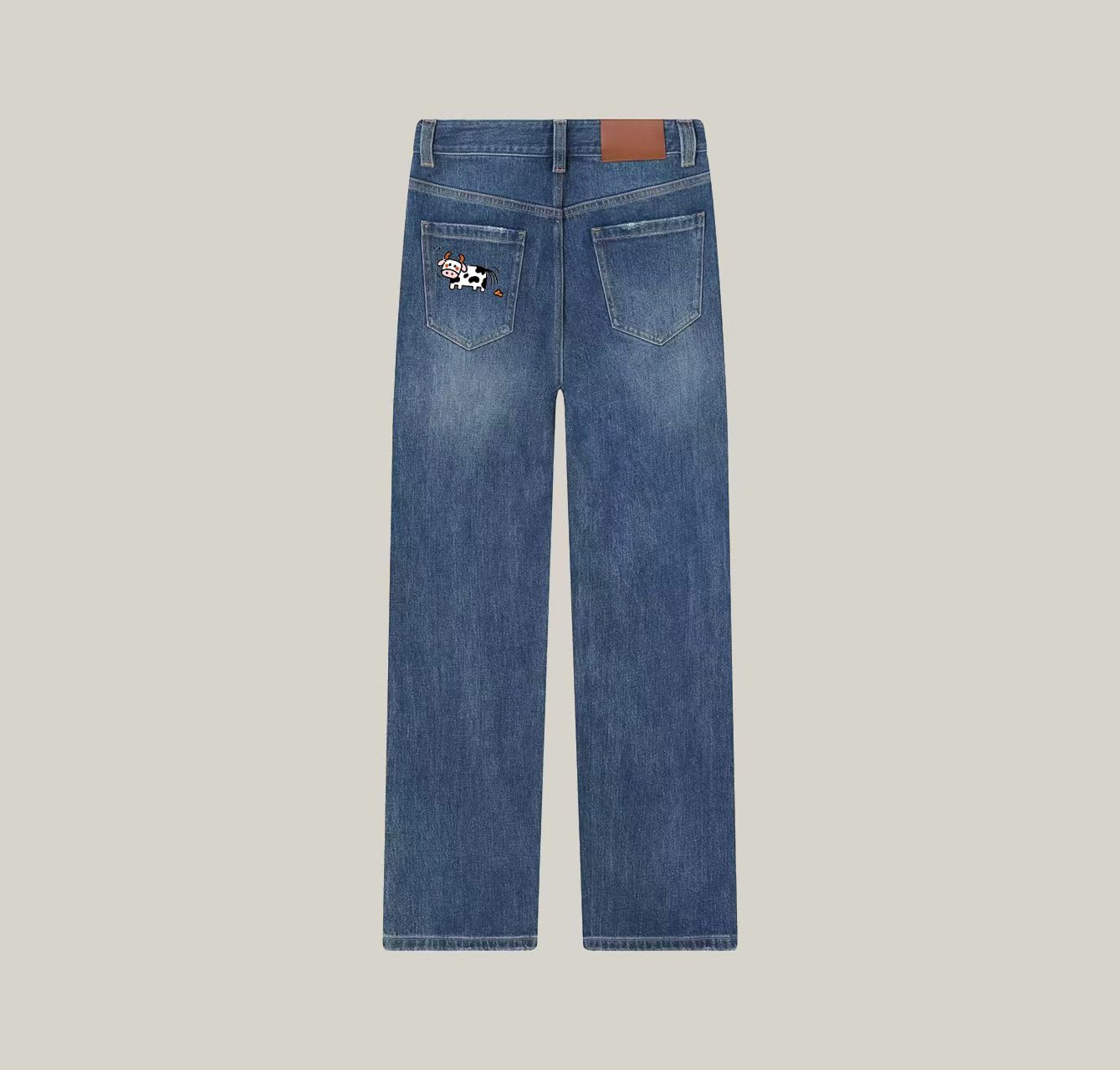 A pair of jeans with a cow print—a wardrobe essential.