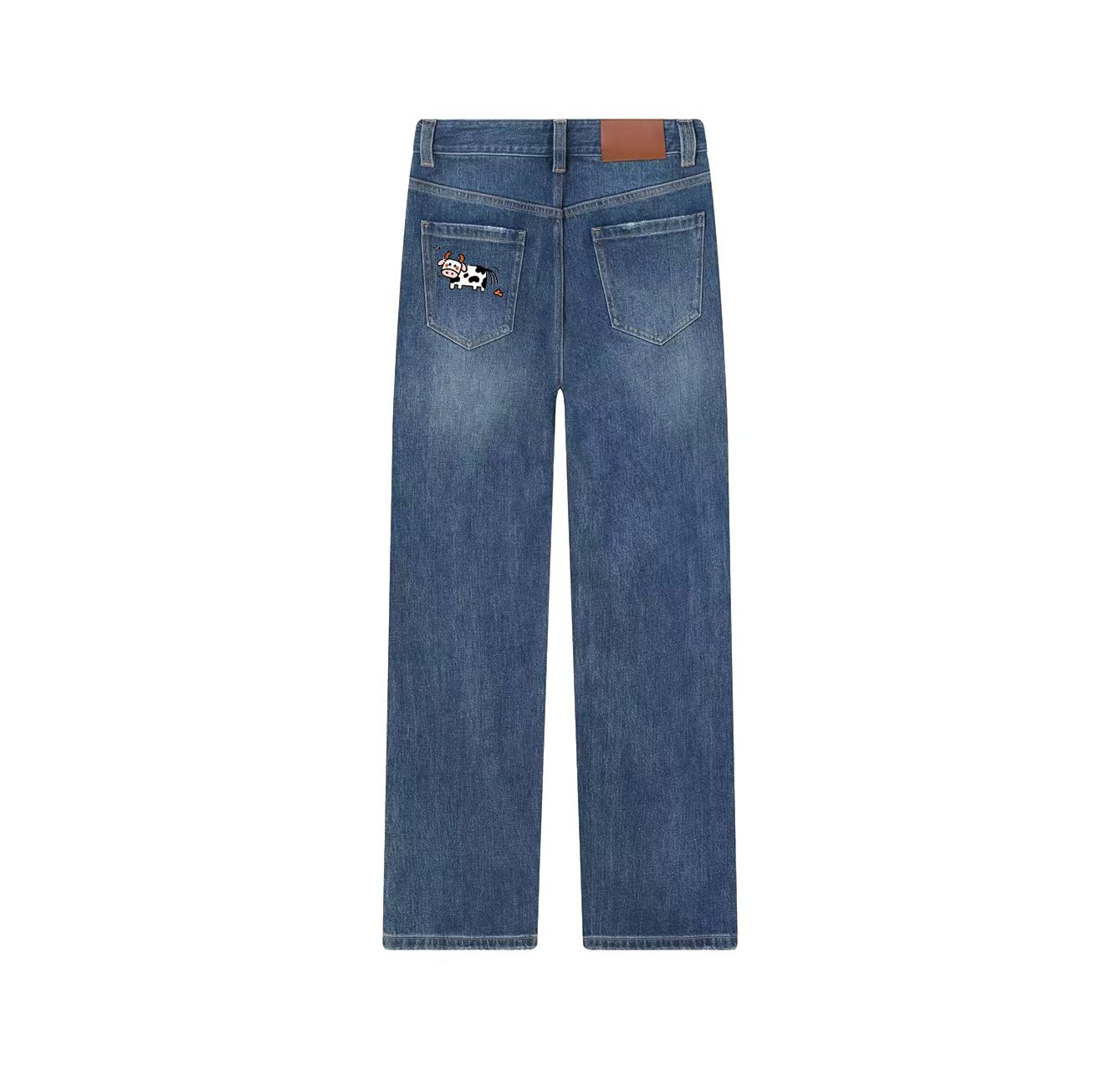 A pair of jeans with a cow print—a wardrobe essential.