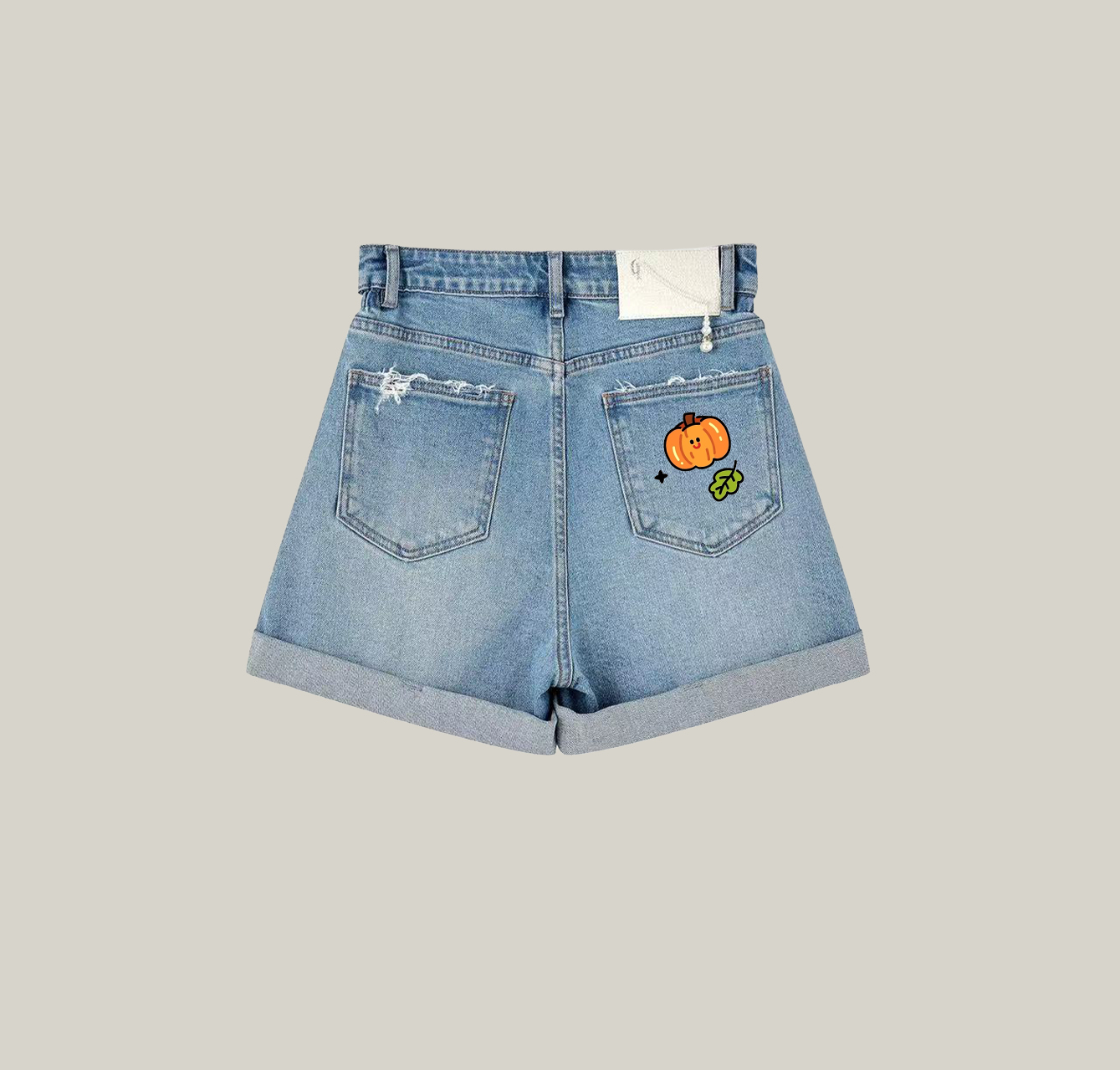 A pair of denim shorts with a pumpkin pattern is a must-have item in your summer wardrobe.