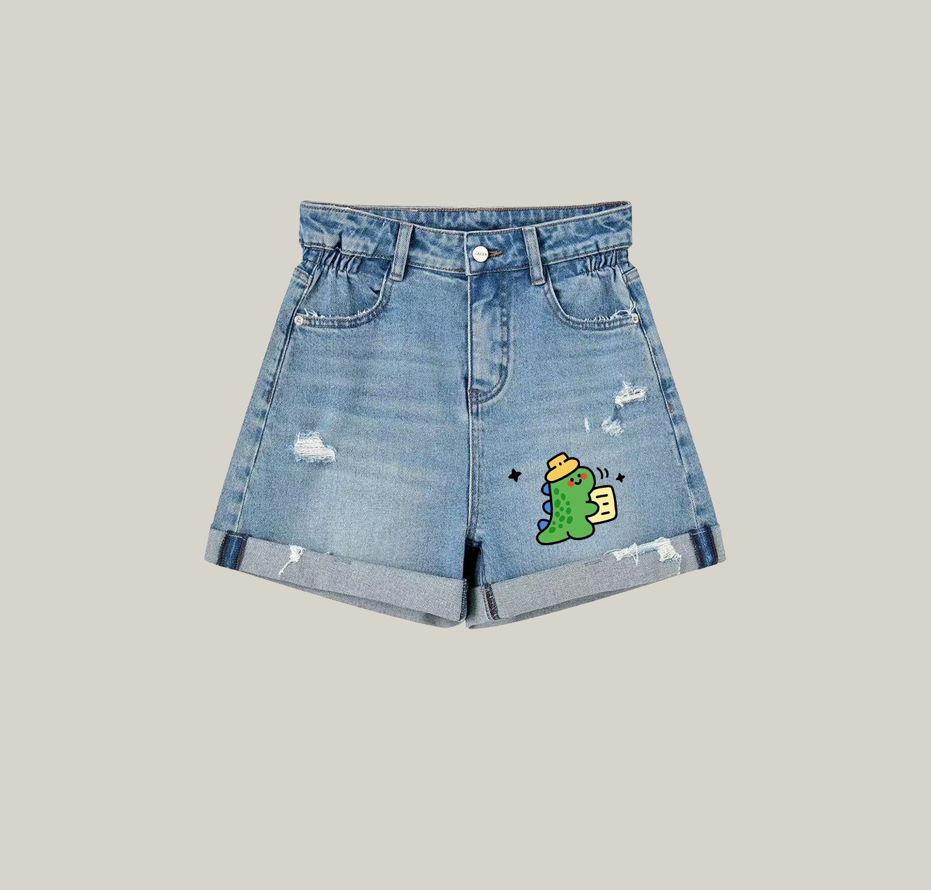 Denim shorts featuring a print of a little dinosaur wearing a hat—an essential item for your summer wardrobe.