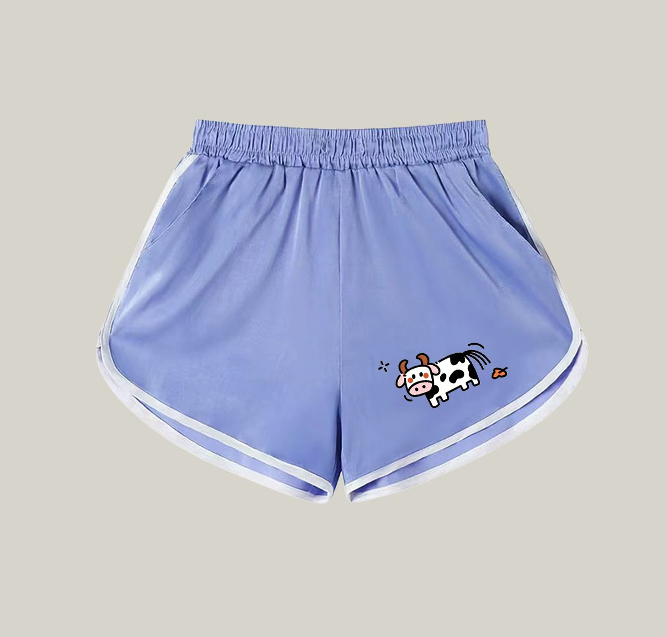 A pair of athletic shorts with a cow pattern—a wardrobe essential.