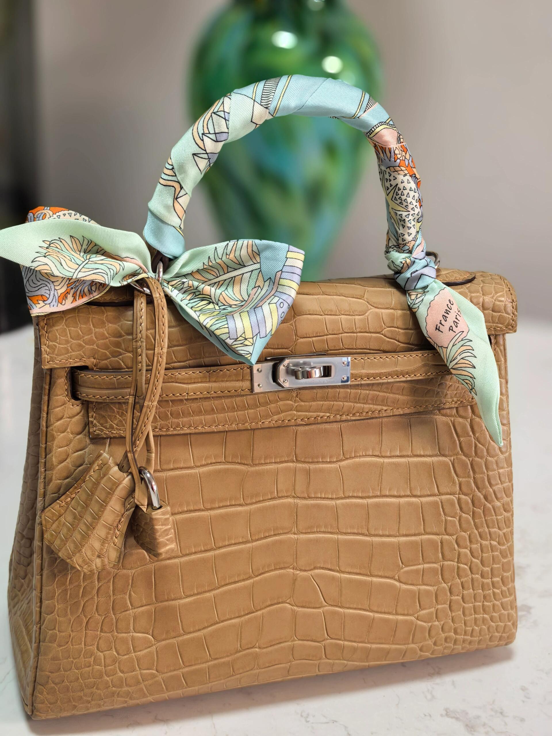 Kelly25. Milk tea color, silver buckle, American alligator