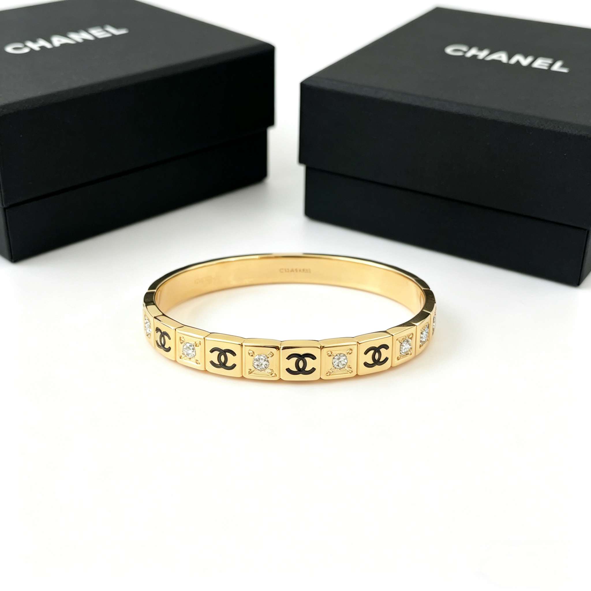C—Single-layer diamond-encrusted multi-logo metal bangle