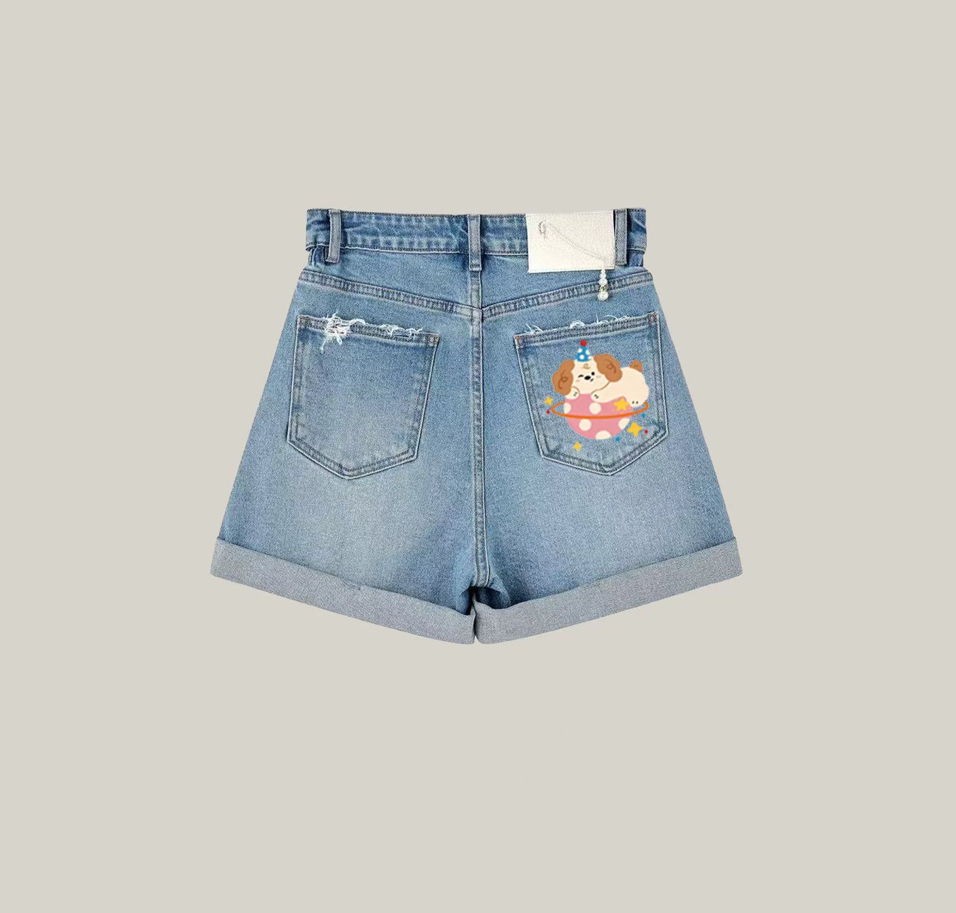 A pair of denim shorts featuring a puppy print—an essential item for your summer wardrobe.