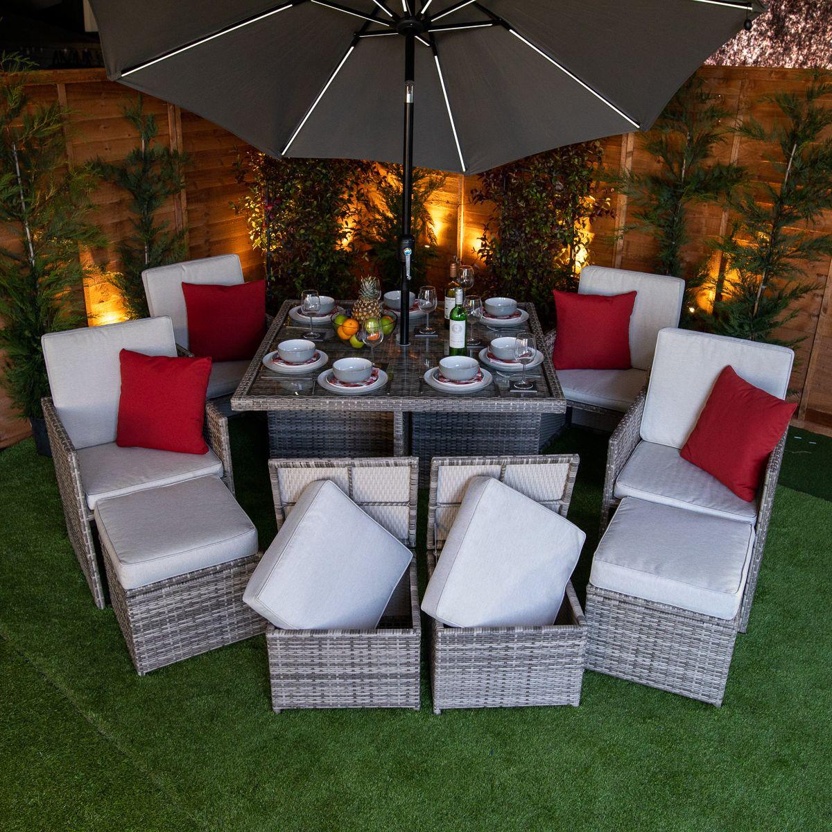 Flat pack 4 seat cube rattan outdoor sofa with 4 footrests.