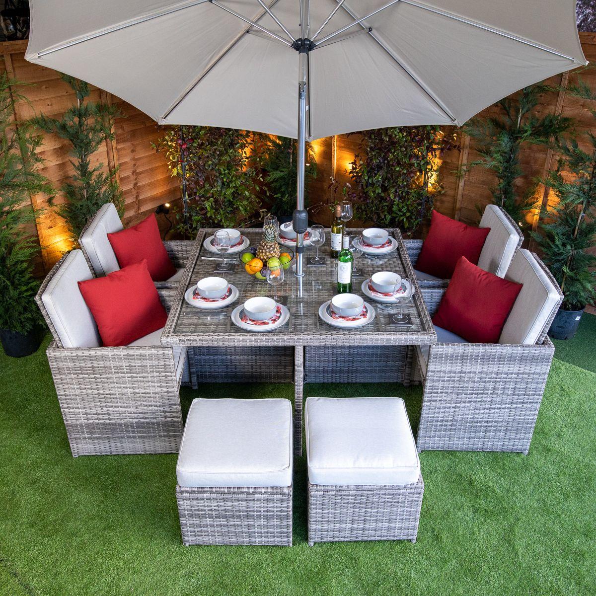 Flat pack 4 seat cube rattan outdoor sofa with 4 footrests.