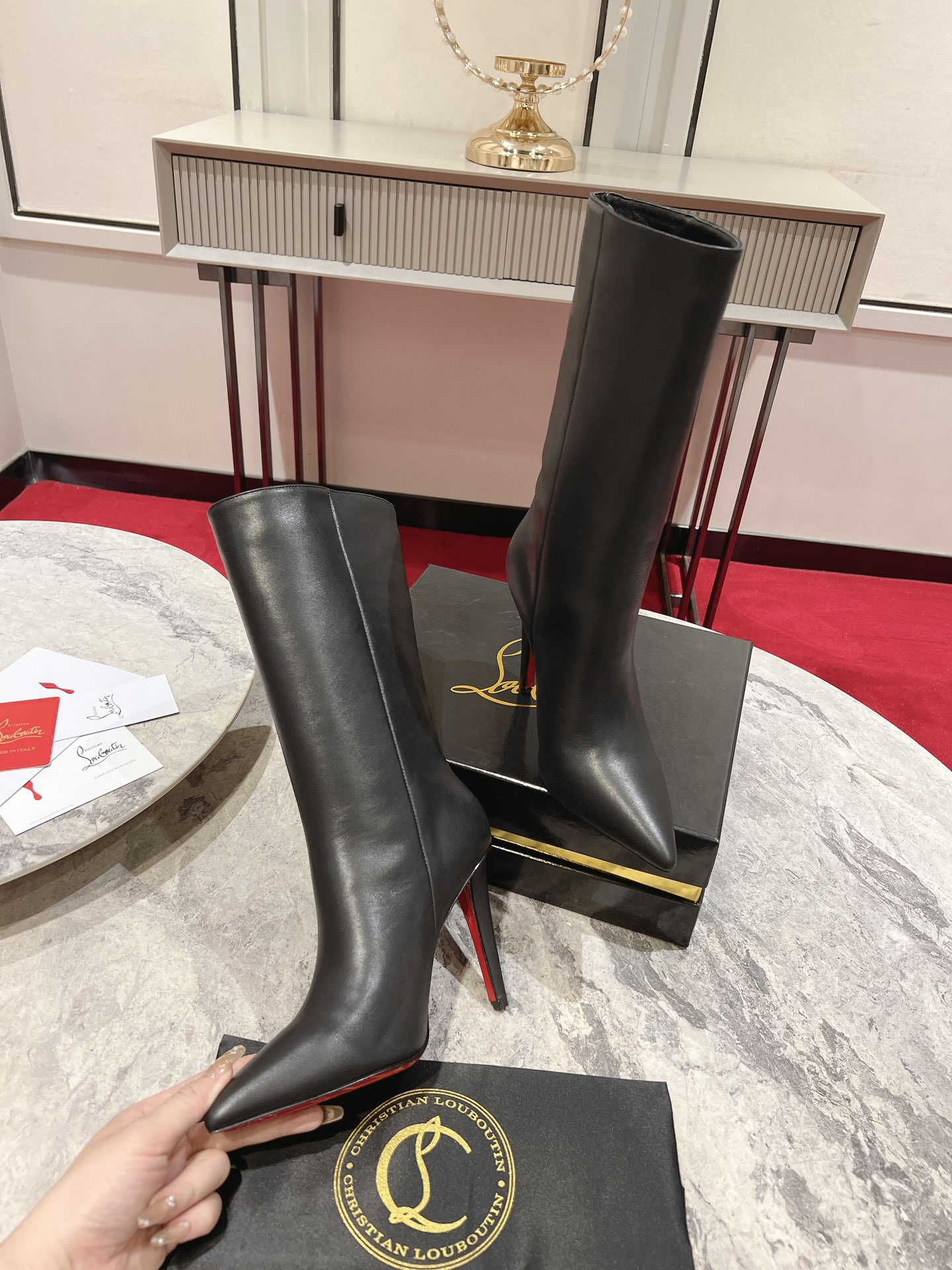 Christian Louboutin red-soled long bootsThe Astrilarge Booty mid-calf boots