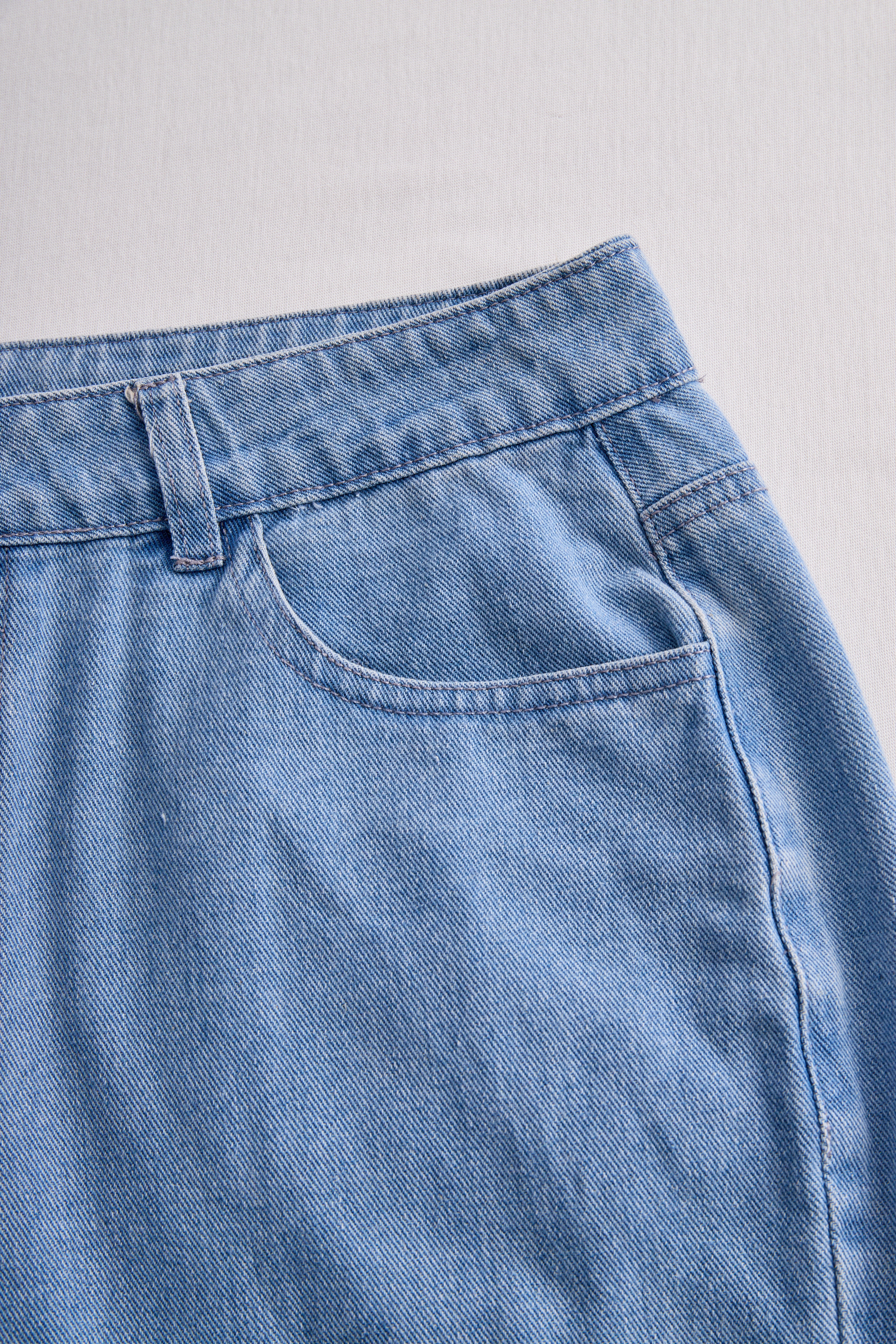 Stylish Denim Two-Piece Set With Asymmetrical Top And Fringed Skirt